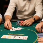 Poker players sitting at a table, following proper etiquette with chips and cards